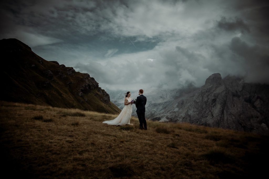 Bride and groom eloping in the Dolomites during a moody autumn day